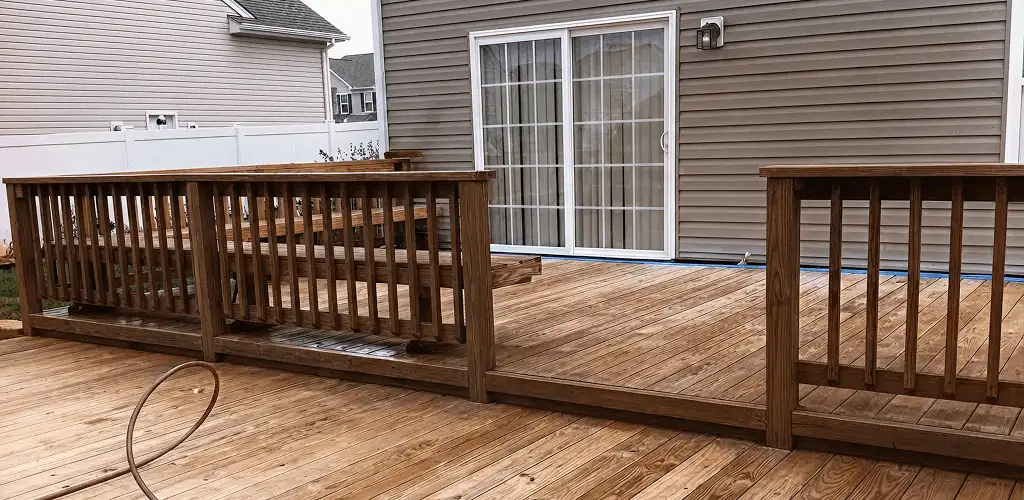 Deck sealing service protecting a backyard wood deck and railings in Cedar Rapids, IA
