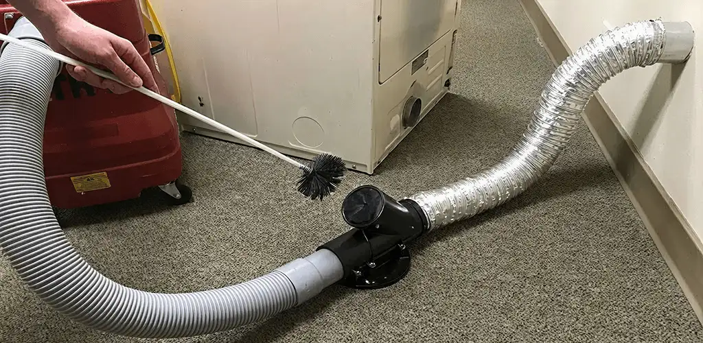 Dryer vent cleaning service removing lint from a dryer duct connection in Cedar Rapids, IA
