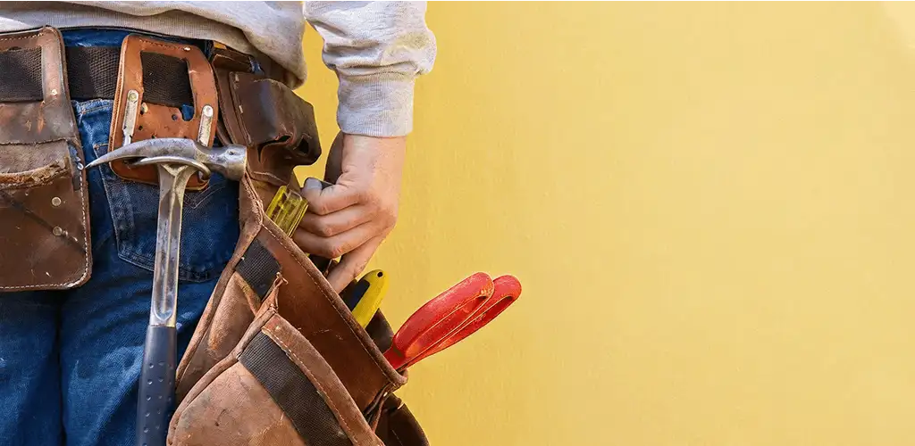 Handyman with tool belt ready for home repairs and maintenance in Cedar Rapids, IA