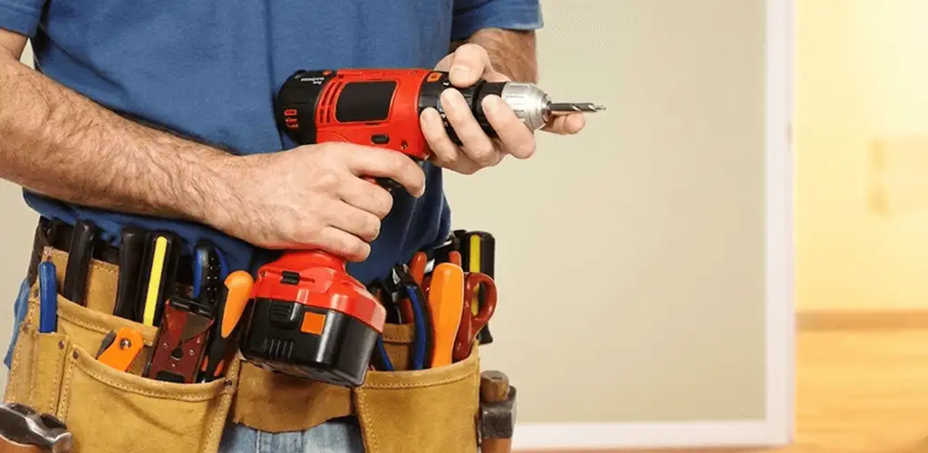 Handyman holding a power drill for home repairs and installations in Cedar Rapids, IA