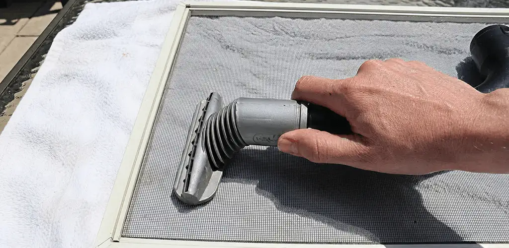 Window screen repair cleaning and fixing a damaged screen mesh in Cedar Rapids, IA