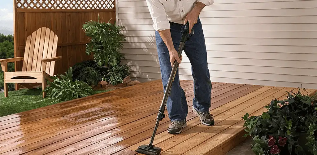 Deck staining service applying stain to a backyard wood deck in Cedar Rapids, IA